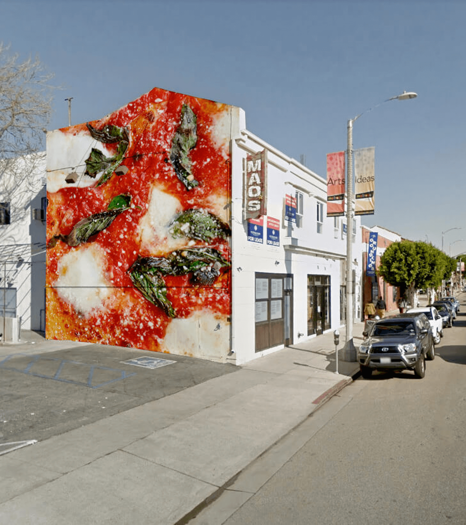 Cover for Ronan showing the side of the restaurant with a mural of a close-up pizza