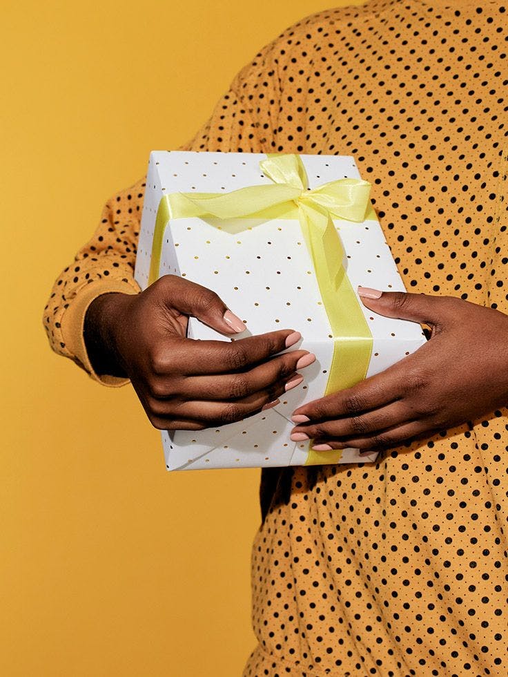 Cover for Wrap + Deliver showing a wrapped present being held